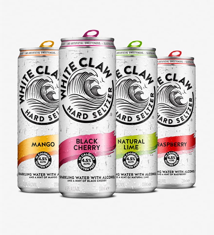 Four cans of WHITE CLAW® on a grey background