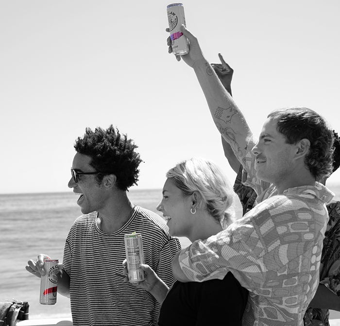 A group of friends enjoy some Raspberry WHITE CLAW® Hard Seltzer