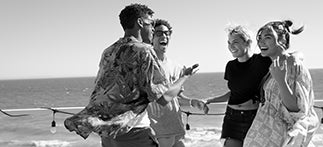 Friends are seen chatting on the beach.